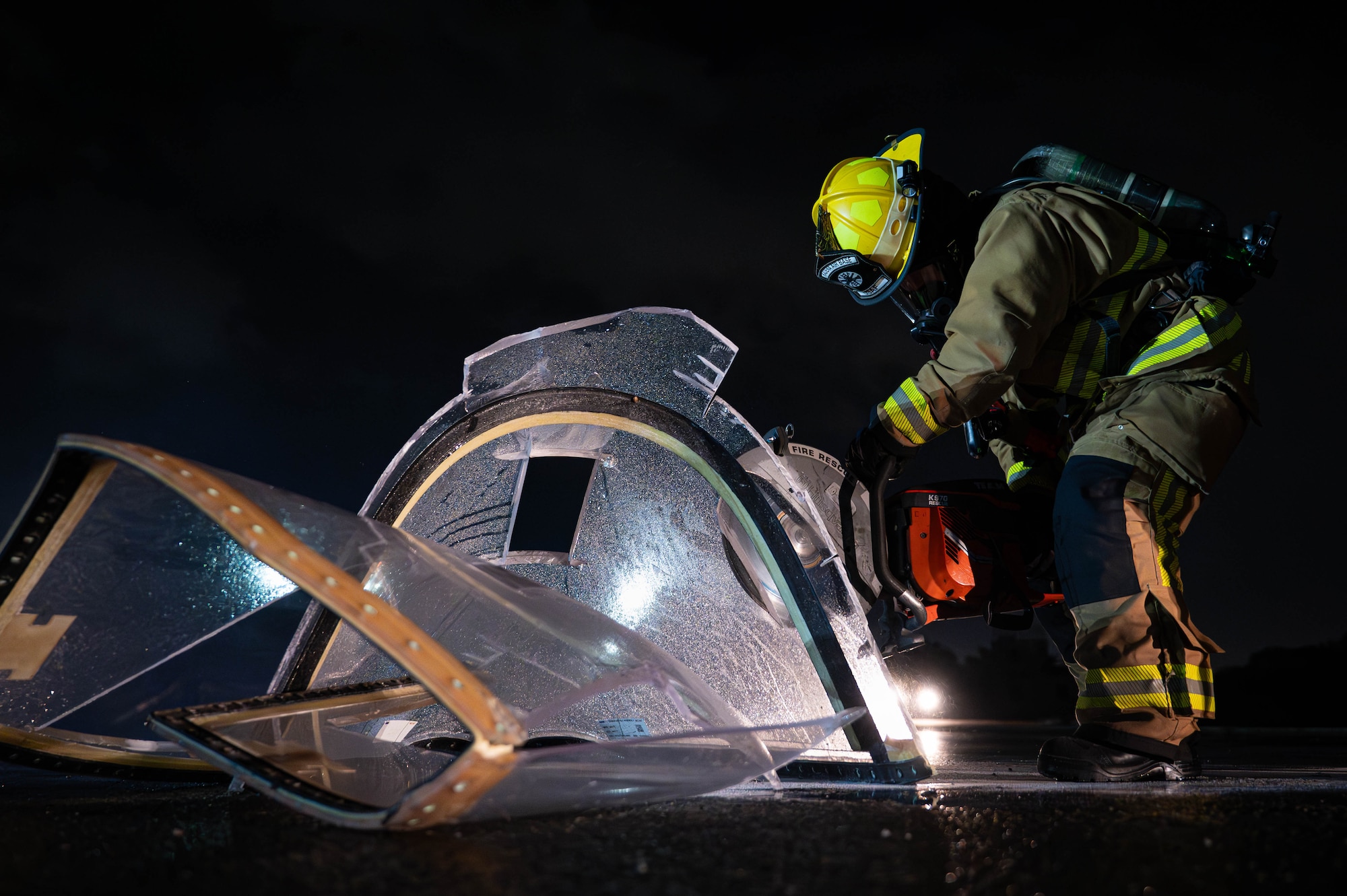 A U.S. Air Force 18th Civil Engineer Squadron firefighter cuts into a simulated aircraft canopy during U.S. Air Force-led operational exercise, Beverly Midnight 26 at Kadena Air Base, Japan, March 12, 2026. Training events like this improve coordination and readiness across allied forces in the Indo-Pacific. (Photo by U.S. Air Force Airman 1st Class Nathaniel Jackson)