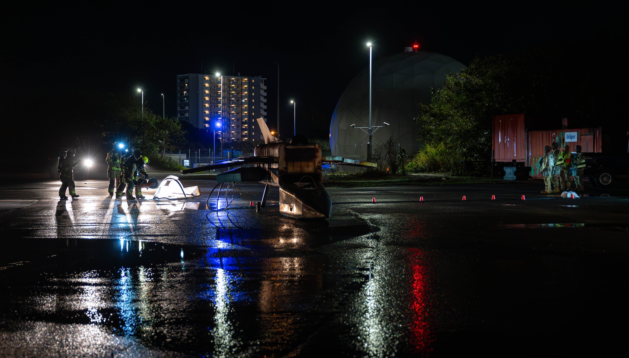 U.S. Air Force 18th Civil Engineer Squadron firefighters hose down a simulated aircraft on fire, during U.S. Air Force-led operational exercise, Beverly Midnight 26 at Kadena Air Base, Japan, March 12, 2026. Training events like this improve coordination and readiness across allied forces in the Indo-Pacific. (Photo by U.S. Air Force Airman 1st Class Nathaniel Jackson)