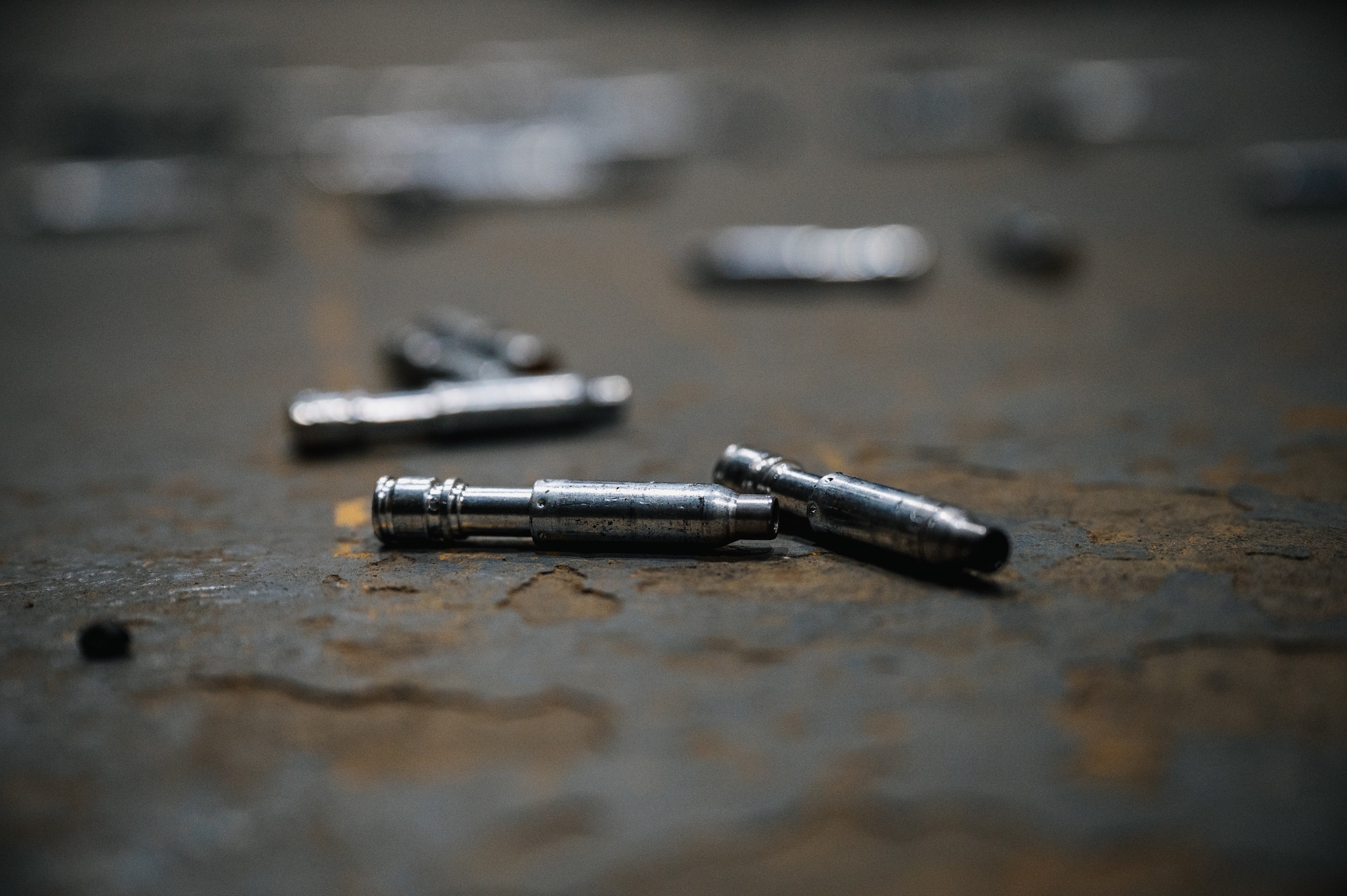 Simulated bullet shell casings lie on the ground.