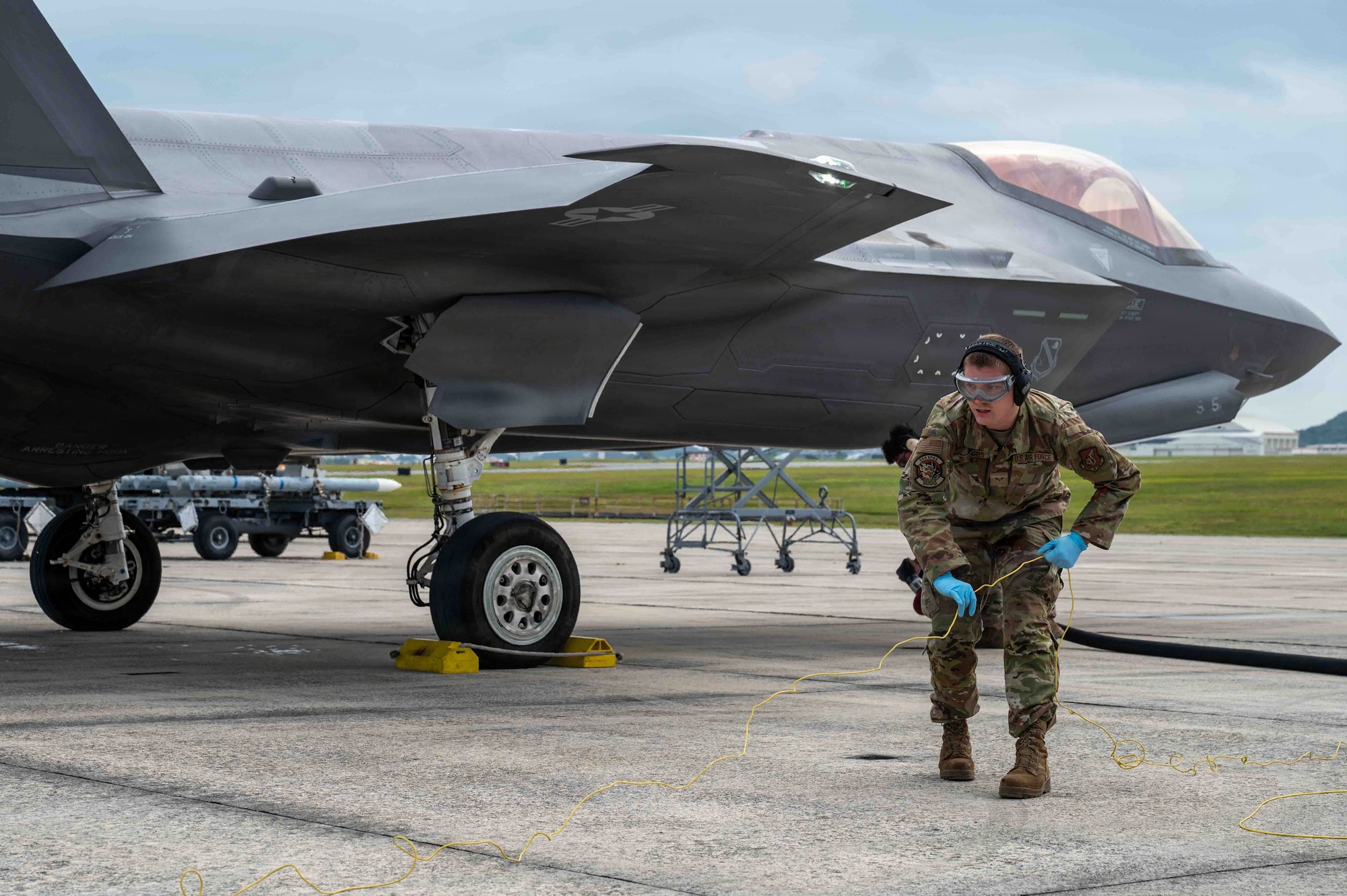 Airman preparing for hot pit refueling.