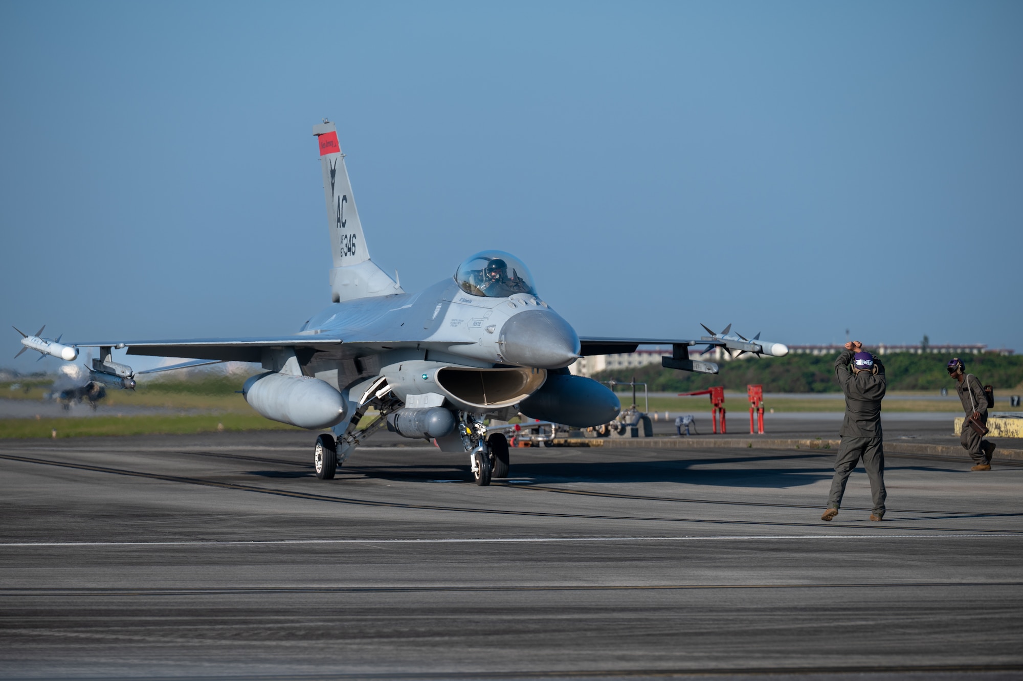 A U.S. Air Force F-16C Fighting Falcon assigned to the 120th Expeditionary Fighter Squadron, deployed to Kadena Air Base, undergoes hot pit refueling by U.S. Marines during a USAF-led operational exercise Beverly Midnight 26, at Marine Corps Air Station Futenma, Japan, March 11, 2026. BM26 tested rapid response capabilities to prepare Airmen for potential emergencies in the Indo-Pacific region. (U.S. Air Force photo by Airman 1st Class Francisco Huerta)