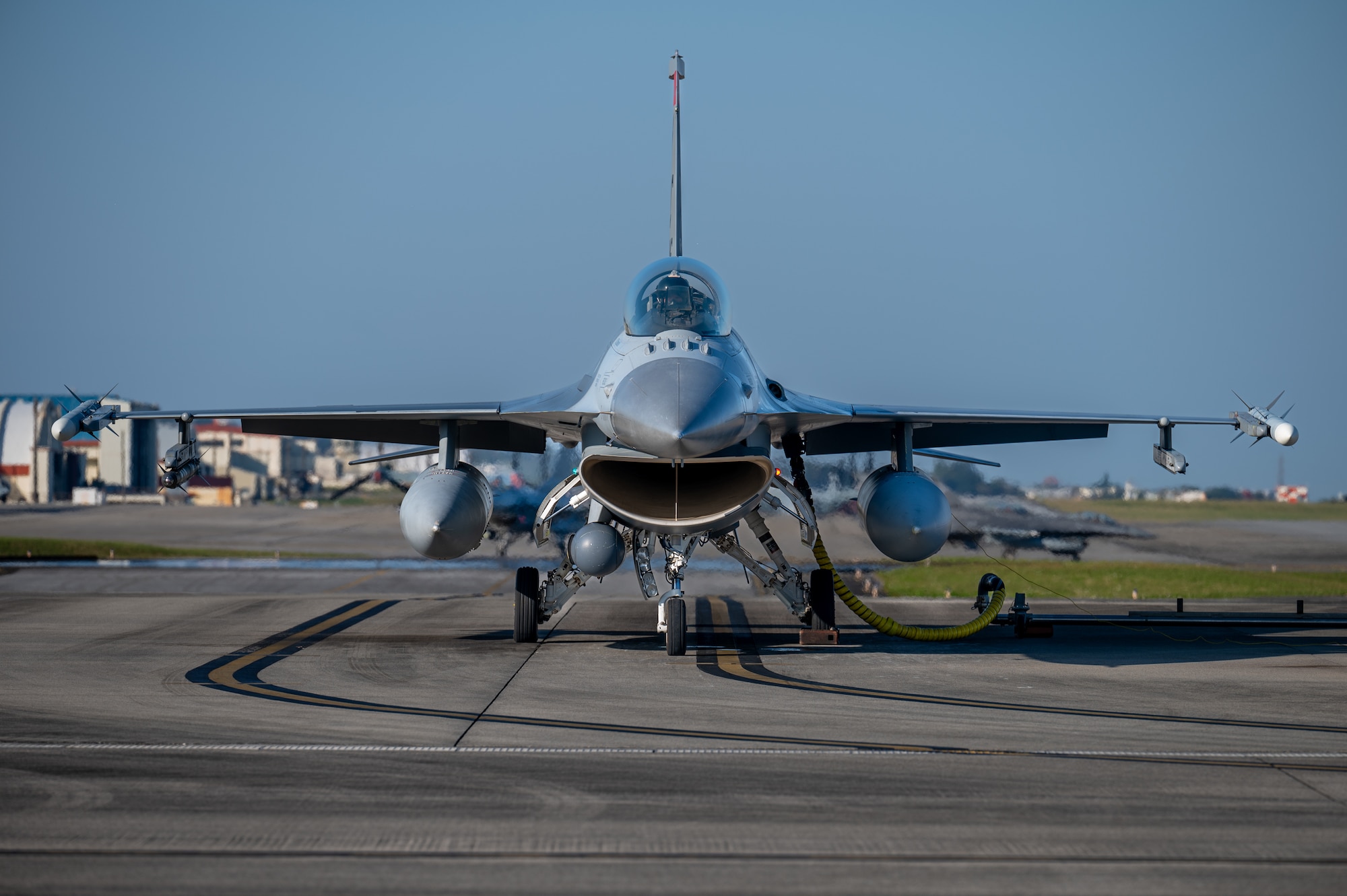 A U.S. Air Force F-16C Fighting Falcon assigned to the 120th Expeditionary Fighter Squadron, deployed to Kadena Air Base, undergoes hot pit refueling by U.S. Marines during a USAF-led operational exercise Beverly Midnight 26 at Marine Corps Air Station Futenma, Japan, March 11, 2026. PACAF forces routinely exercise and train at various locations, demonstrating our collective ability to deploy airpower throughout the Pacific. (U.S. Air Force photo by Airman 1st Class Francisco Huerta)