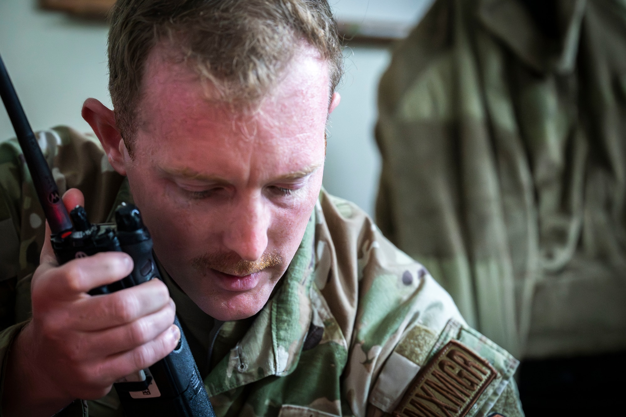 U.S. Air Force Tech. Sgt. John Ward, 18th Maintenance Operations Squadron maintenance manager, speaks into a land mobile radio during a USAF-led operational exercise Beverly Midnight 26 at Kadena Air Base, Japan, March 12, 2026. BM26 tested rapid response capabilities to prepare Airmen for potential emergencies in the Indo-Pacific region. (U.S. Air Force photo by Senior Airman James Johnson)