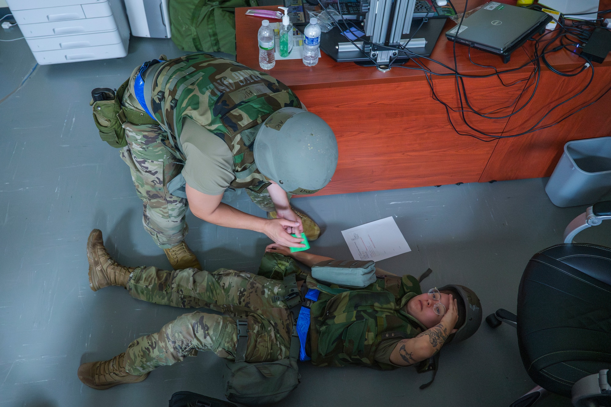 U.S. Air Force Airman 1st Class Samuel Rodriguez, top 18th Maintenance Operations Squadron maintenance manager, converses with Senior Airman Khourey Darby, 18th MOS maintenance manager during a USAF-led operational exercise Beverly Midnight 26 at Kadena Air Base, Japan, March 12, 2026. PACAF forces routinely exercise and train at various locations, demonstrating our collective ability to deploy airpower throughout the Pacific. (U.S. Air Force photo by Senior Airman James Johnson)