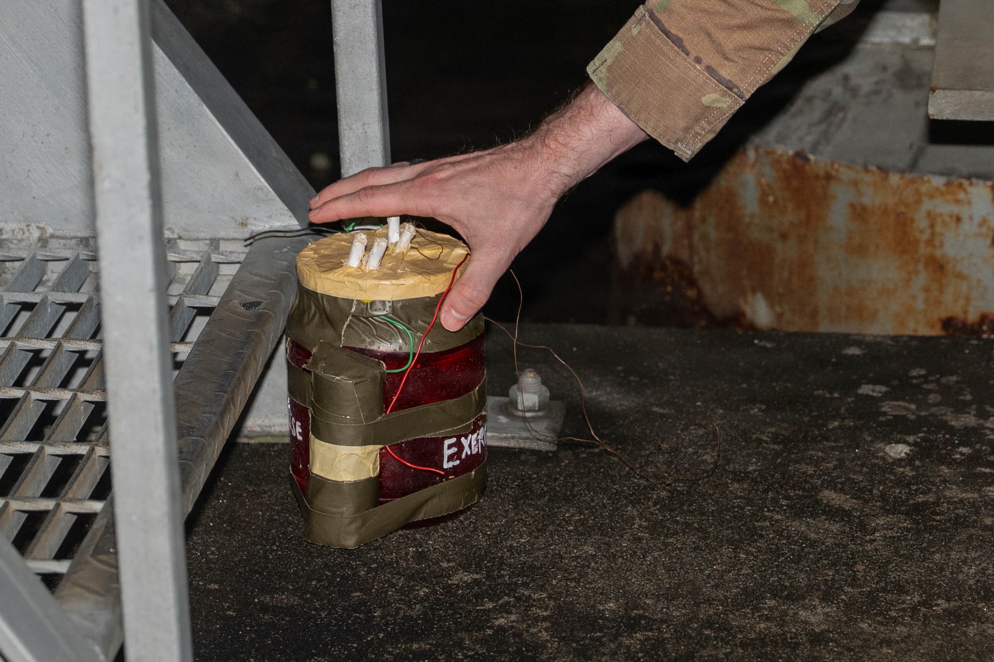 Airman simulating sweep after UXO.