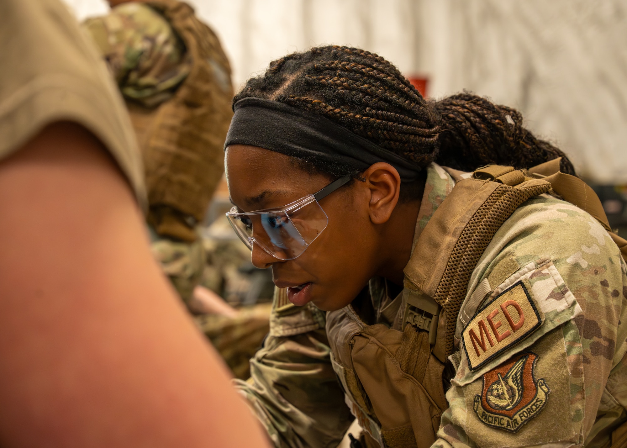 A military medic focuses on starting an IV.