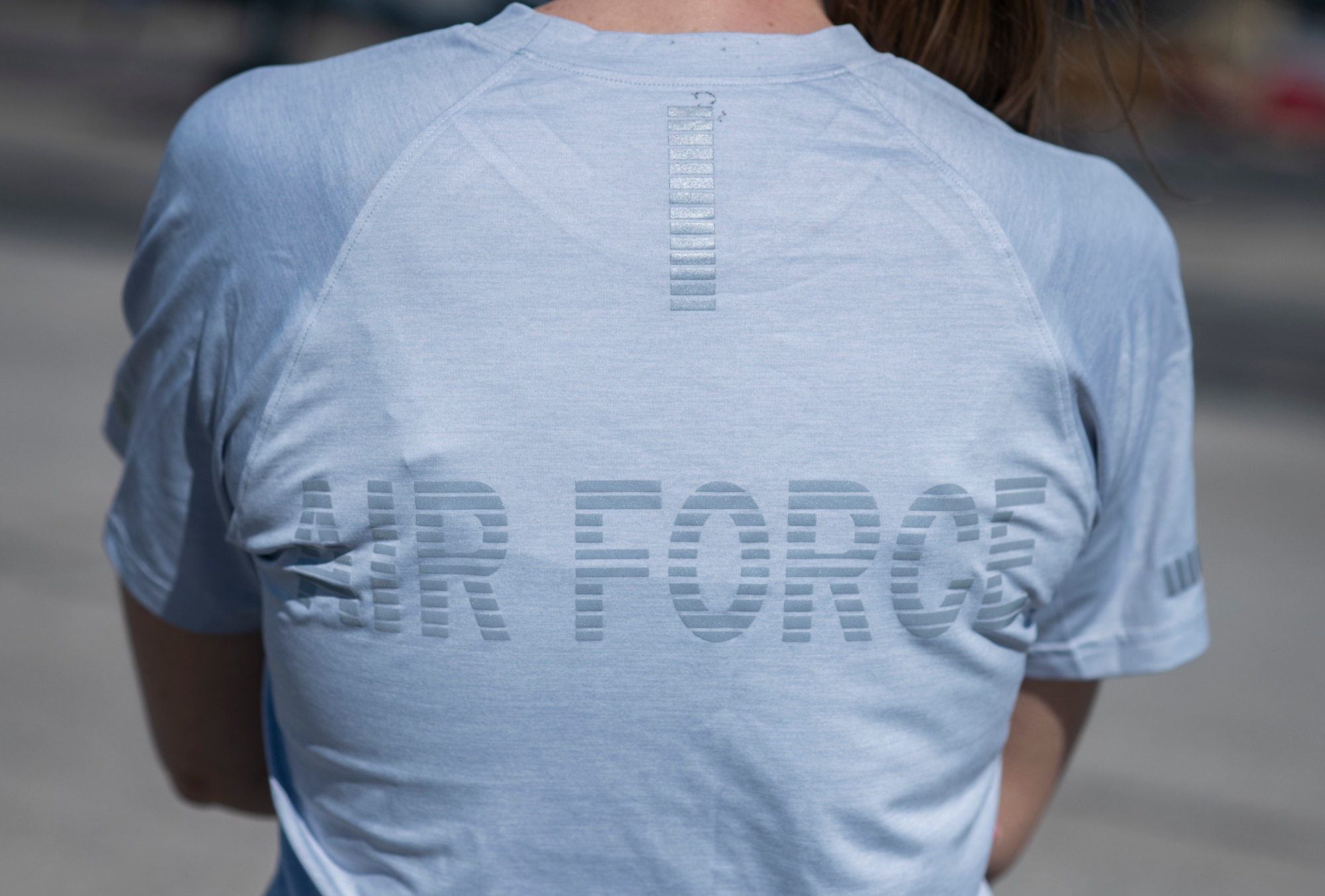 A person stands with the back of their shirt reading 'Air Force.'
