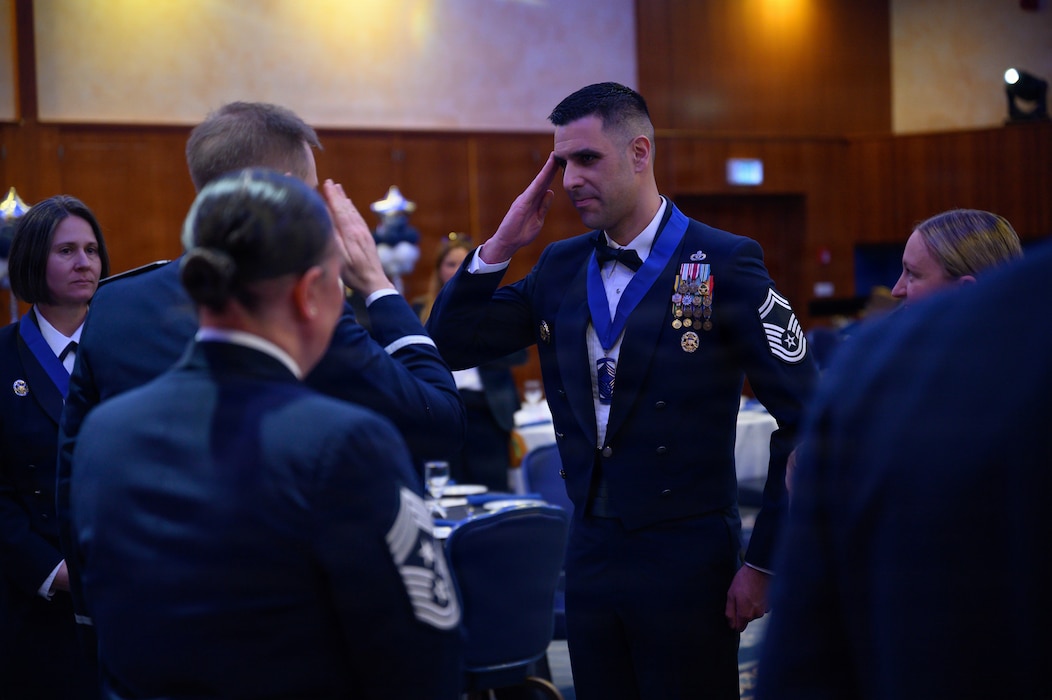 A Chief Master Sgt. select salutes a Col.