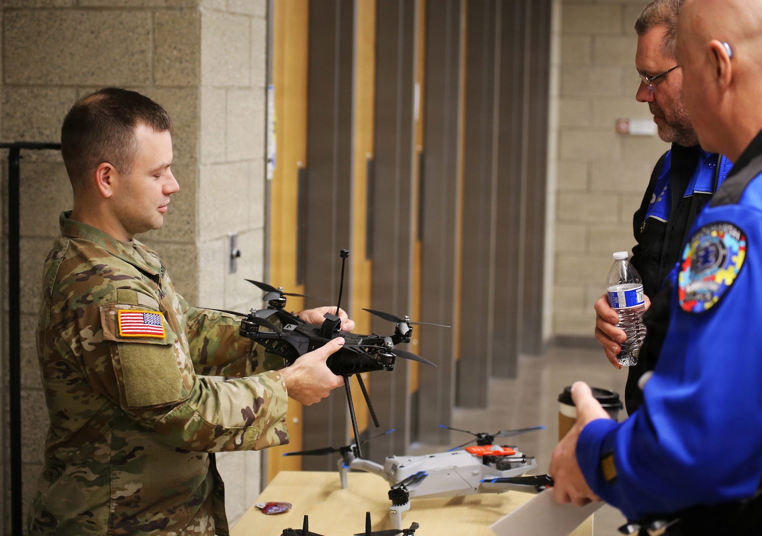 Maj. Andriy Karpenko, UAS/C-UAS officer, Washington National Guard Counterdrug Program, discusses different UAS, or unmanned aerial systems, operating systems with police officers at the 2026 Tribal Police Leadership & Counterdrug Conference March 10, 2026, at the Thurston County Readiness Center, Tumwater, Wash.