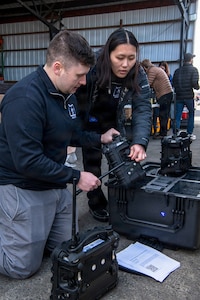 Oregon Army National Guard Sgt. Charles Russell and Spc. Daniella Terawaki, both with the 102nd Oregon CBRNE Enhanced Response Force Package, examine and pack up their air monitoring equipment after completing a joint training exercise with the Clackamas Fire Department and the Gresham Fire Department at a training site in Clackamas, Oregon, on Feb. 26, 2026.