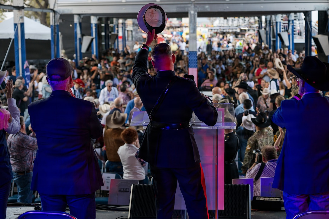 U.S. Marine Corps Lt. Gen. Leonard F. Anderson IV, commander of Marine Forces Reserve and Marine Forces South, raises his cover in recognition of the oldest veteran in attendance, U.S. Army Pvt Chester “Buck” Sloan (Ret.), a WWII veteran and member of the ”Greatest Generation” at the Houston Livestock Show and Rodeo Armed Forces Appreciation Day in Houston, March 4, 2026. Armed Forces Appreciation Day honored nearly 4,000 military personnel and veterans, including a joint service enlistment ceremony for approximately 500 recruits. (U.S. Marine Corps photo by SSgt. Ethan M. LeBlanc)