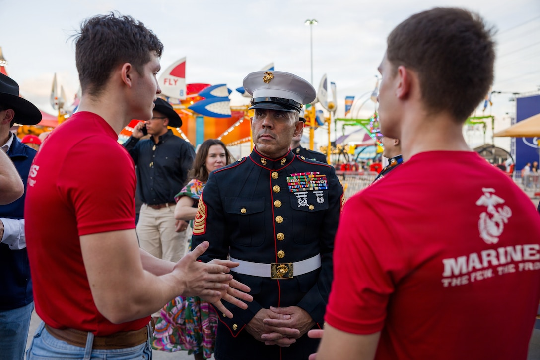 U.S. Marine Corps Sgt. Maj. Edwin A. Mota, command senior enlisted leader of Marine Forces Reserve and Marine Forces South, talks with newly sworn-in Marine recruits at the Houston Livestock Show and Rodeo Armed Forces Appreciation Day in Houston, March 4, 2026. Armed Forces Appreciation Day honored nearly 4,000 military personnel and veterans, including a joint service enlistment ceremony for approximately 500 recruits. (U.S. Marine Corps photo by SSgt. Ethan M. LeBlanc)