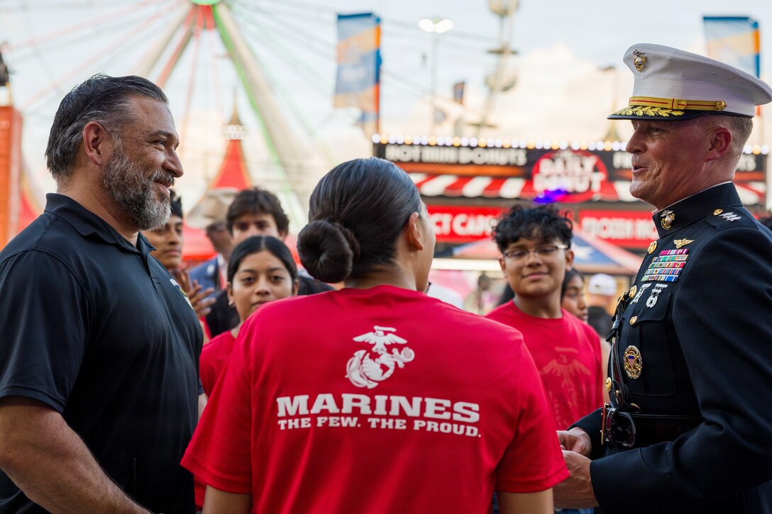 U.S. Marine Corps Lt. Gen. Leonard F. Anderson IV, commander of Marine Forces Reserve and Marine Forces South, talks with the parent of a newly sworn-in Marine recruit at the Houston Livestock Show and Rodeo Armed Forces Appreciation Day in Houston, March 4, 2026. Armed Forces Appreciation Day honored nearly 4,000 military personnel and veterans, including a joint service enlistment ceremony for approximately 500 recruits. (U.S. Marine Corps photo by SSgt. Ethan M. LeBlanc)