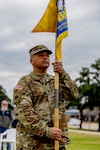 Oklahoma Army National Guard Capt. Eric Langley, commander of the Southeastern Oklahoma State University Guard Officer Leadership Development (GOLD) program, stands with the newly uncased guidon at a flagging ceremony for the SEOSU’s GOLD program held Wednesday, March 11, 2026 in Durant, Oklahoma. The OKARNG’s GOLD program is designed to develop and prepare individuals for commissioned officer roles, equipping them with the skills needed to lead Soldiers effectively. Upon completion, candidates will attend Officer Candidate School. Once a candidate has completed the GOLD and OCS programs, they will become commissioned officers. (Oklahoma National Guard photo by Sgt. Haden Tolbert)