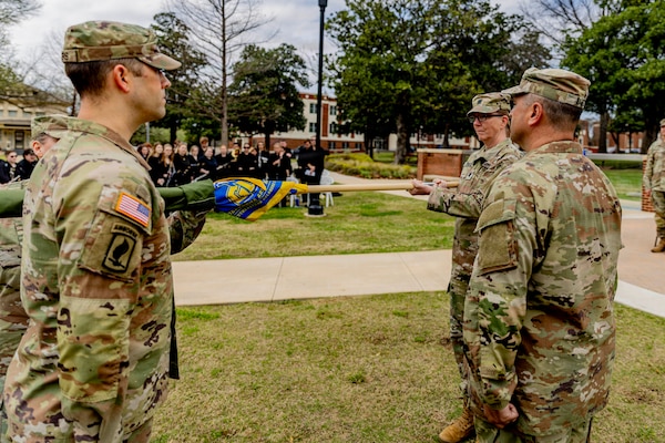 Lt. Col. Richelle Treece, commander of 2nd Battalion, 189th Regiment, Regional Training Institute, Oklahoma Army National Guard, uncases the guidon for the Southeastern Oklahoma State University’s Guard Officer Leadership Development (GOLD) program, March 11, 2026. The OKARNG’s GOLD program is designed to develop and prepare individuals for commissioned officer roles, equipping them with the skills needed to lead Soldiers effectively. Upon completion, candidates will attend Officer Candidate School. Once a candidate has completed the GOLD and OCS programs, they will become commissioned officers. (Oklahoma National Guard photo by Sgt. Haden Tolbert)