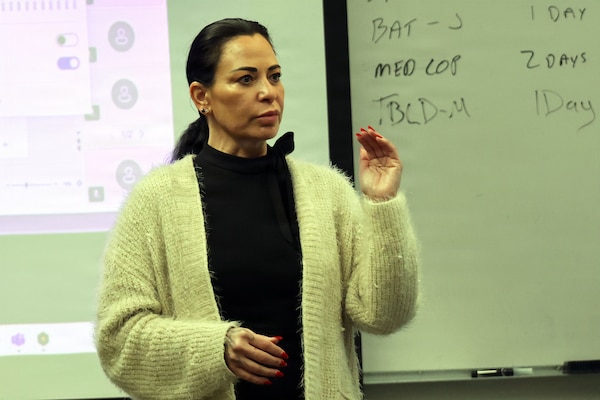 Nikki Stevenson, the Joint Operational Medicine Information Systems government training lead, explains to subject matter experts their critical role in finalizing the Naval Training Systems Plan at the Surface Warfare Medical Institute in San Diego, Feb. 24, 2026. The NTSP is a comprehensive training plan for the Navy's next-generation operational medical technology, which will modernize electronic health records for the fleet.