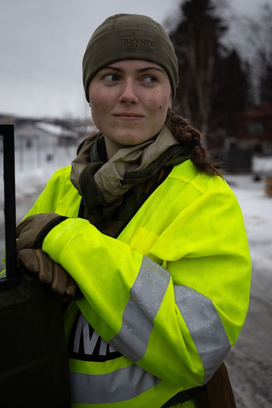 A member of the Norwegian forces waits to direct traffic during a convoy in Narvik, Norway, Mar. 5, 2026. Norwegian forces and U.S. Marines partnered to direct traffic and provide security in support of exercise Cold Response 26. A key component of NATO's enhanced vigilance activity Arctic Sentry, exercise Cold Response 26 is a Norwegian-led winter military exercise designed to enhance collective defense capabilities and ensure U.S. readiness to rapidly deploy and seamlessly operate alongside NATO Allies in challenging arctic conditions. (U.S. Marine Corps photo by Sgt. Emily De La Torre)
