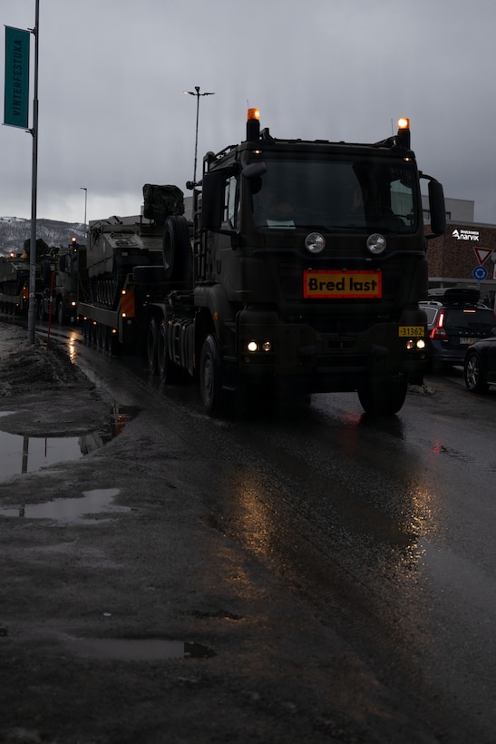 Norwegian vehicles conduct a convoy in Narvik, Norway, March 5, 2026. The convoy was part of the logistical movements for exercise Cold Response 26, which were secured through a partnership between Norwegian forces and U.S. Marines. A key component of NATO's enhanced vigilance activity Arctic Sentry, exercise Cold Response 26 is a Norwegian-led winter military exercise designed to enhance collective defense capabilities and ensure U.S. readiness to rapidly deploy and seamlessly operate alongside NATO Allies in challenging arctic conditions. (U.S. Marine Corps photo by Sgt. Emily De La Torre)