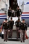 U.S. Army Soldiers with the Kansas City Recruiting Battalion carefully carry a secured document case down the steps of the “Freedom Plane” upon its arrival at the downtown airport, March 2, 2026. The Soldiers assisted with the ceremonial arrival and helped ensure the safe transfer of historic materials for transport to the museum for secure storage and display.