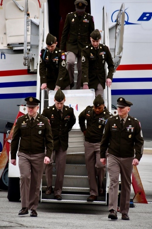 U.S. Army Soldiers with the Kansas City Recruiting Battalion carefully carry a secured document case down the steps of the “Freedom Plane” upon its arrival at the downtown airport, March 2, 2026. The Soldiers assisted with the ceremonial arrival and helped ensure the safe transfer of historic materials for transport to the museum for secure storage and display.