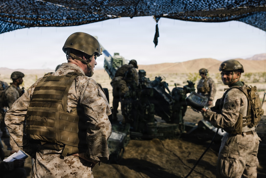 U.S. Marine Corps Brig. Gen. John Jarrard, a Georgia native, commanding general of 4th Marine Division, observes a fire mission during a Mobile Assault Course as part of Service Level Training Exercise 1-26 at Marine Corps Air Ground Combat Center, Twentynine Palms, California, Feb. 5, 2026. The MAC provides a training unit with a combined-arms environment, a defined battlespace, and an unknown enemy situation to conduct assault and defense scenarios using multiple engagement areas, areas of interest, and a coordinated fire support plan. (U.S. Marine Corps photo by Cpl. Damian Oso)