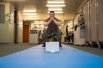 Hospital Corpsman Conor Tucker from the Naval Medical Center Portsmouth's physical therapy department demonstrates physical therapy moves while the Sword Thrive technology monitors his form and suggests corrections.