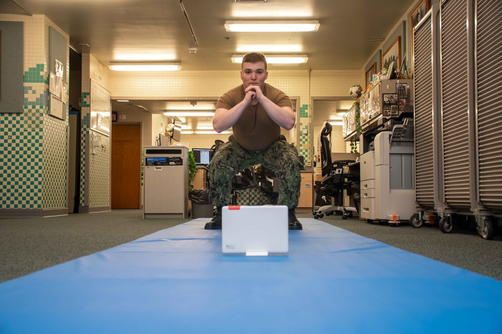 Hospital Corpsman Conor Tucker from the Naval Medical Center Portsmouth's physical therapy department demonstrates physical therapy moves while the Sword Thrive technology monitors his form and suggests corrections.
