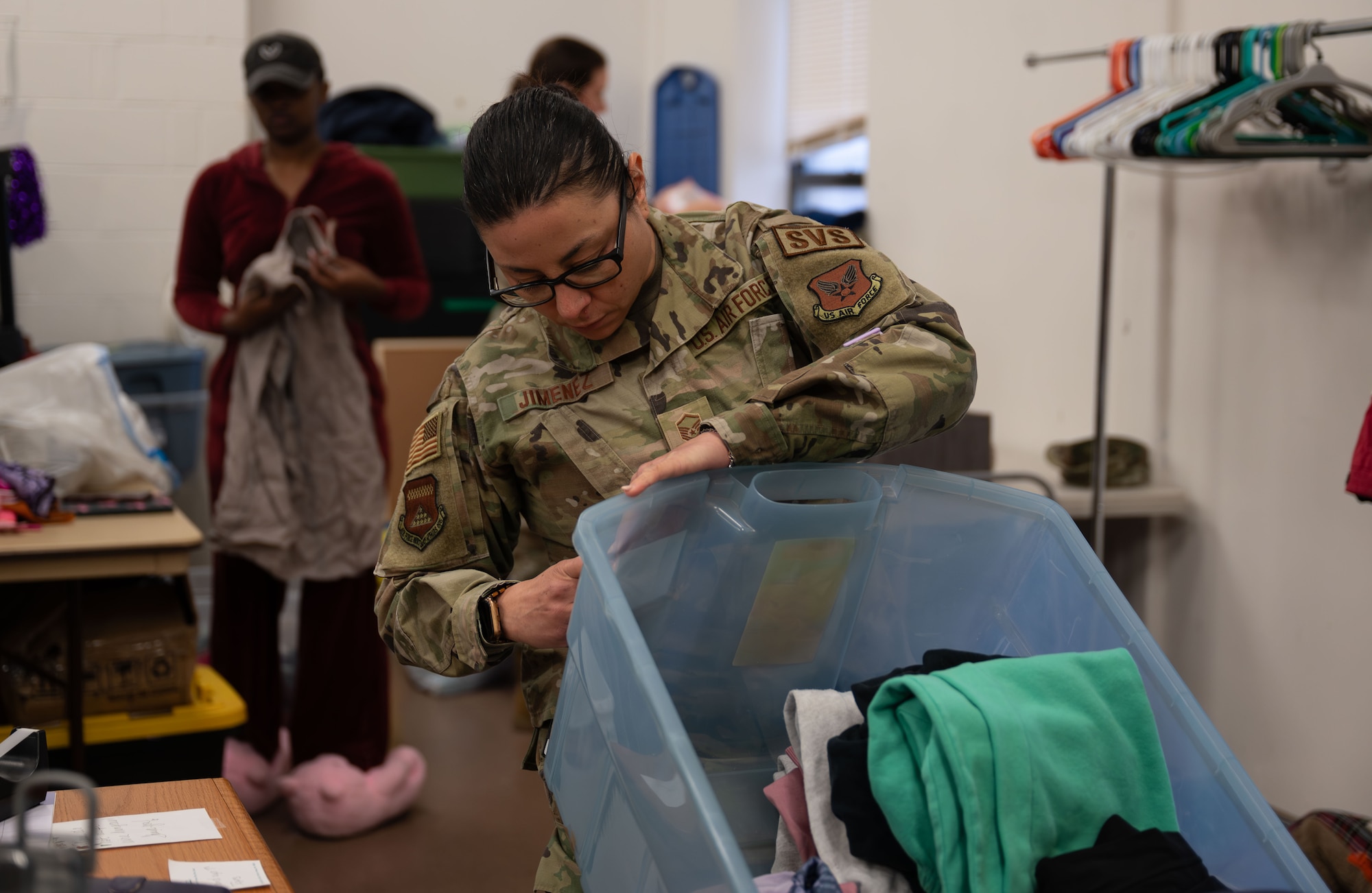 U.S. Air Force Reserve Master Sgt. Christina Jimenez, 512th Memorial Affairs Squadron dress and restoration noncommissioned officer in charge, organizes clothing in tubs at the Airmen’s Attic on Dover Air Force Base, Delaware, March 2, 2026. Volunteers are able to track their hours volunteering to use for awards packages and enlisted performance briefs. (U.S. Air Force photo by Airman 1st Class Liberty Kuhn)