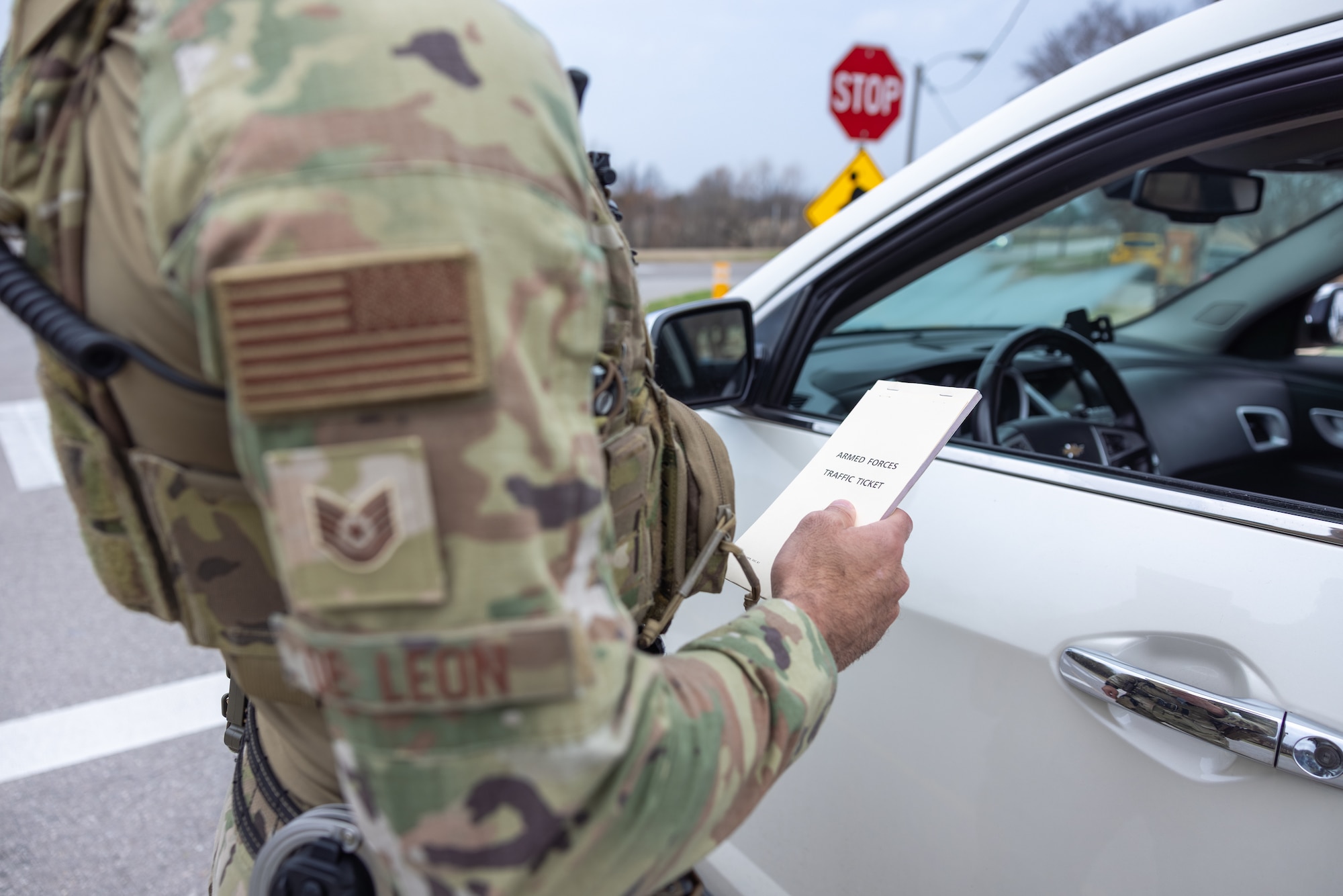 Man standing in front of vehicle.