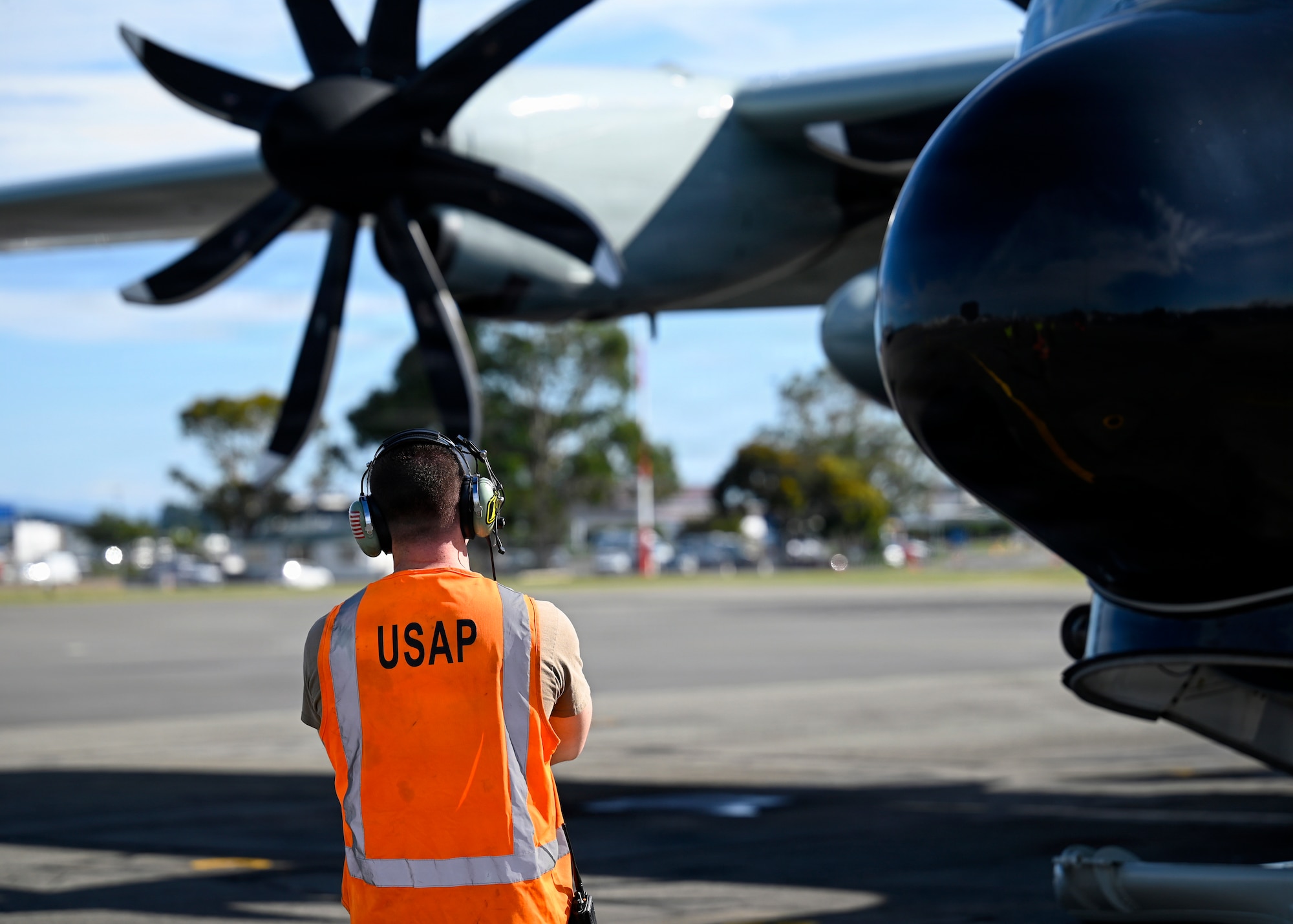 Airman stands in front of aircraft