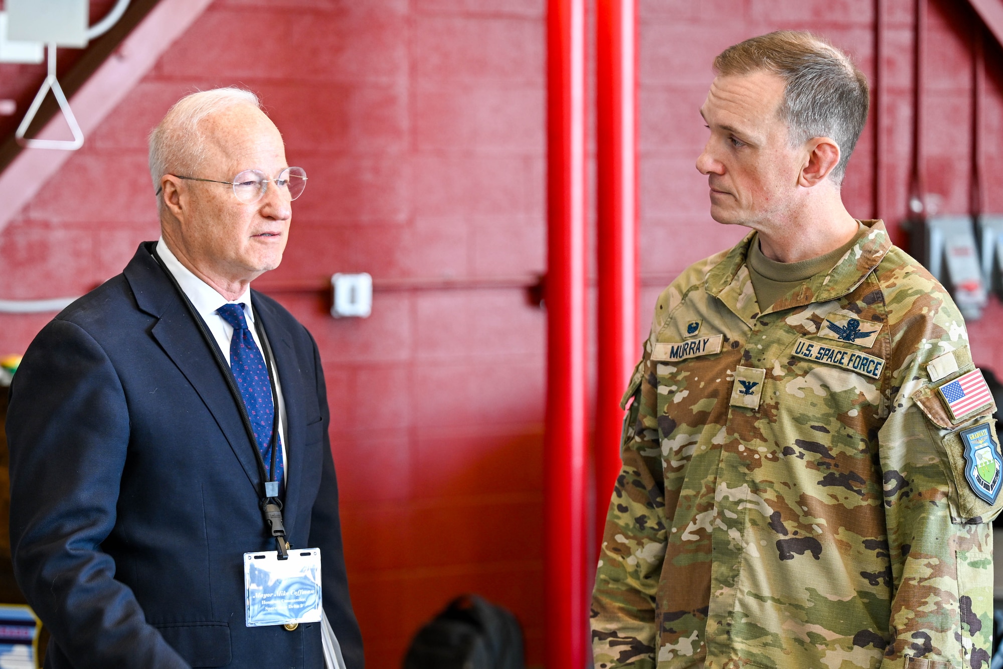 two men talking in hangar