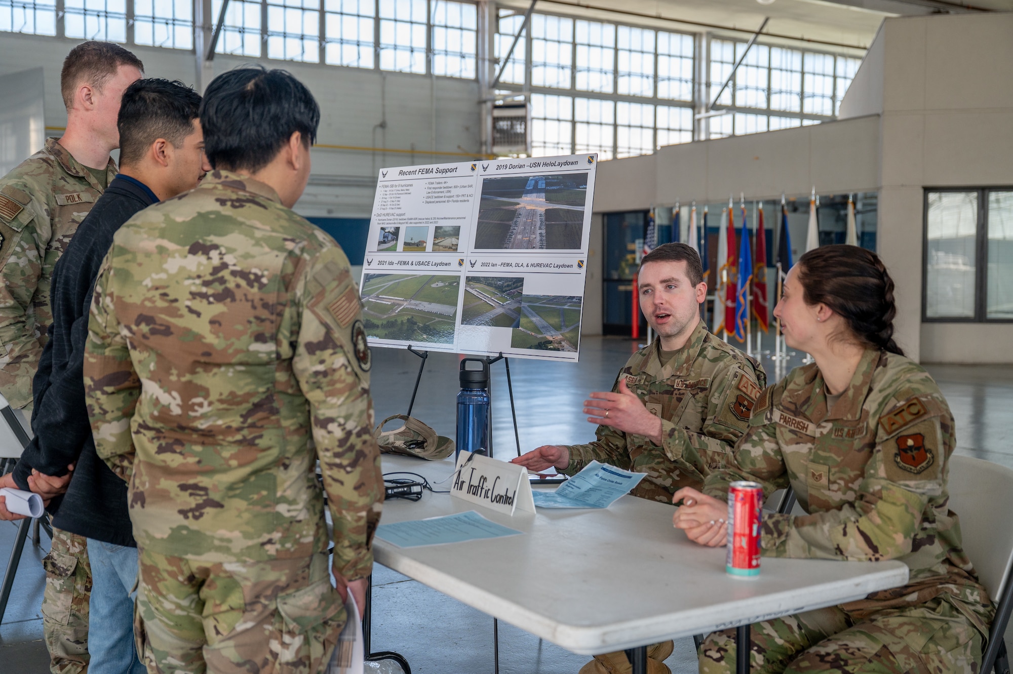 Maxwell Air Force Base Airmen gather to discuss about an Air Force Specialty Code in the honor guard hangar.