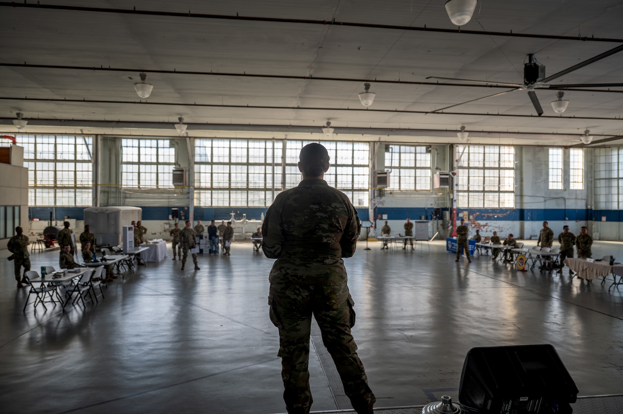Maxwell Air Force Base Airmen gather to listen to a speech inside the honor guard hangar.
