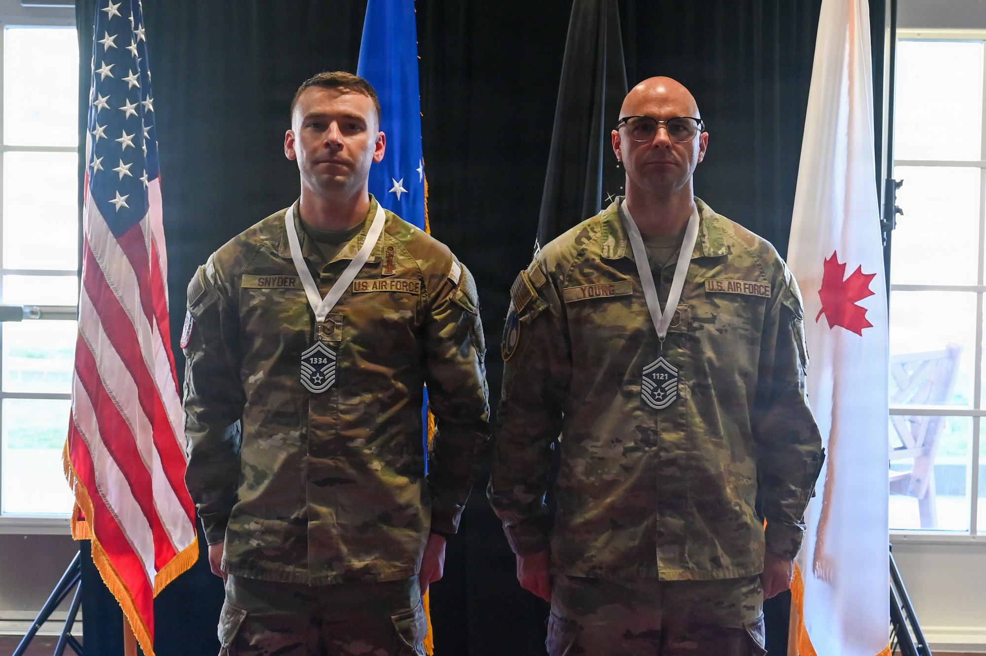 Two Senior Master Sergeant selects stand next to each other and pose for a photo.