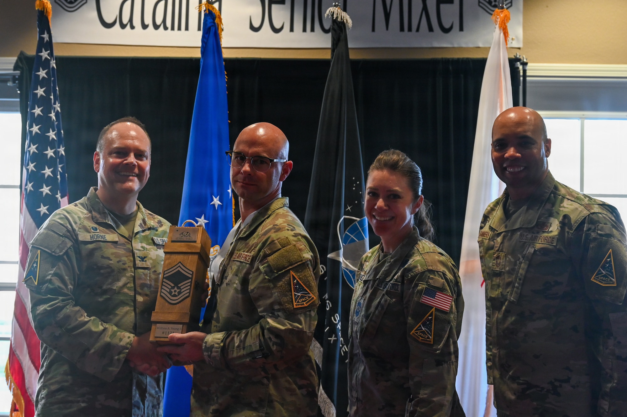 U.S. Air Force Master Sgt. William Young II, 2nd Space Launch Squadron flight chief, a Senior Master Sgt. select, receives a promotion trophy