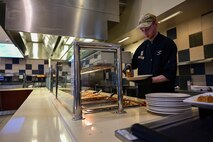 Man serves food.