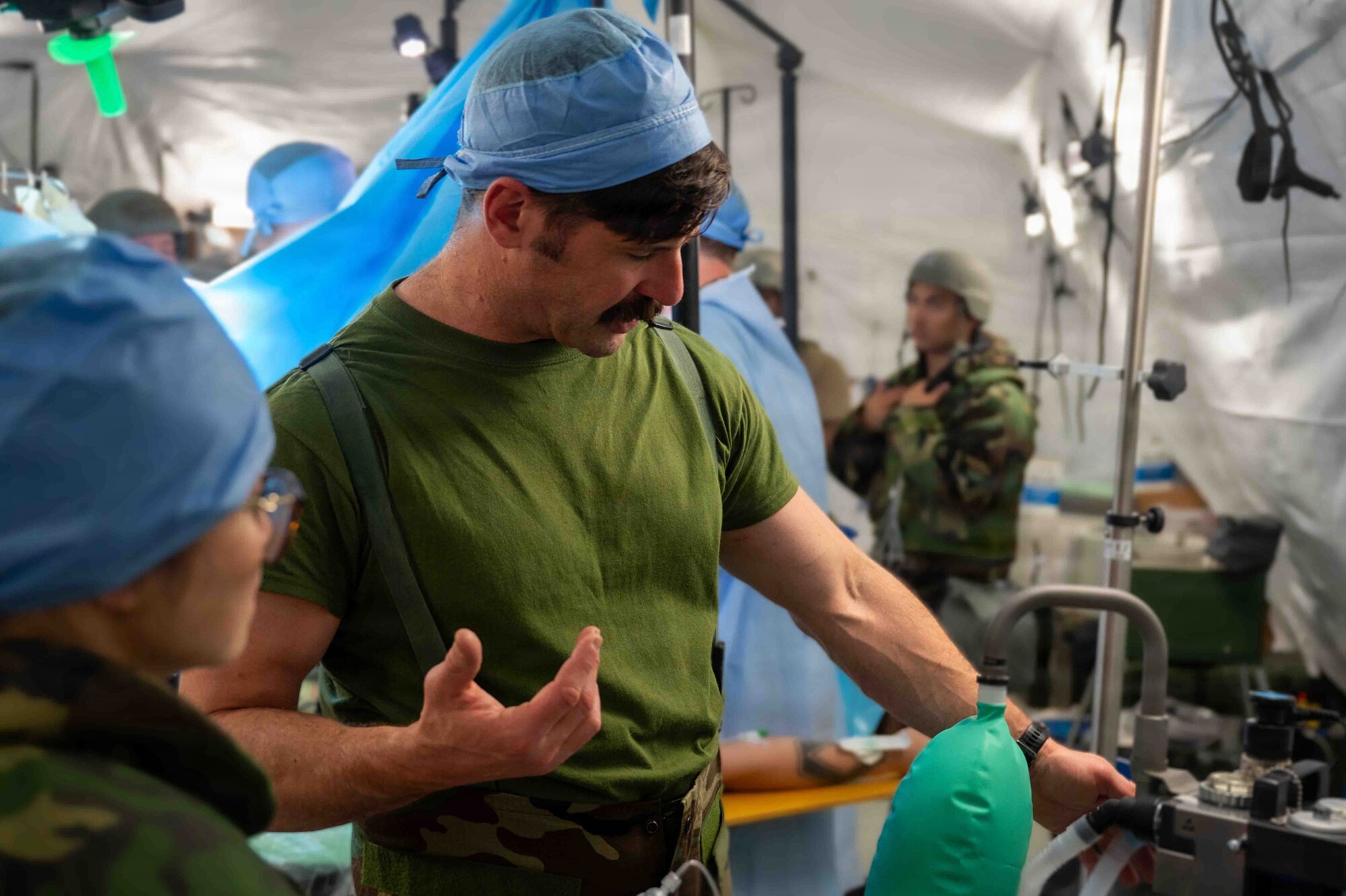 Service member demonstrates a medical device