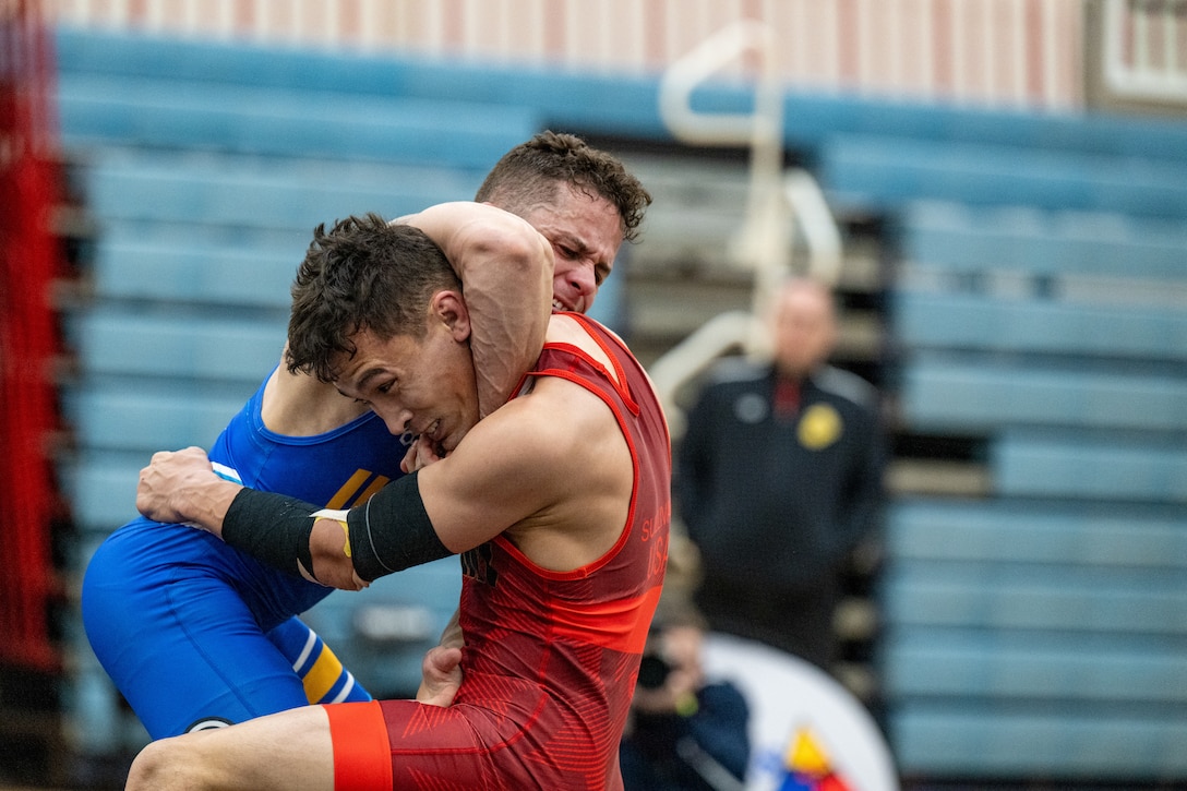 U.S. Marine Corps Staff Sgt. Xavier Medina, assigned to Recruiting Station New Jersey, and U.S. Army Sgt. William Sullivan, assigned to Fort Carson, Colorado, wrestle during the Armed Forces Sports Men’s and Women’s Wrestling Championships at the Mitchell W. Stout Physical Fitness Center on Fort Bliss, Texas, March 14, 2026. Service members compete in Greco-Roman and freestyle wrestling for championship honors while representing their respective services.