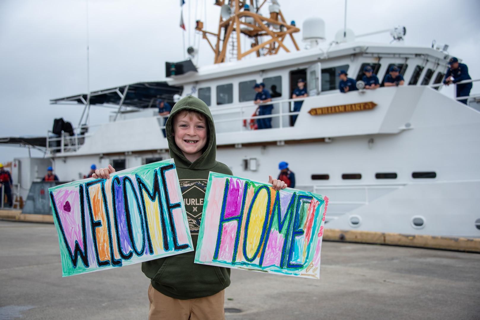 Henry Helsabeck, son of U.S. Coast Guard Lt. Cmdr. Jason Helsabeck, awaits the return of fast response cutter USCGC William Hart (WPC 1134) on Coast Guard Base Honolulu March 15, 2026. Helsabeck, the cutter’s commanding officer, led his crew on a 48-day patrol throughout Oceania, visiting Samoa, Cook Islands, American Samoa, Tonga and Kiribati. (U.S. Coast Guard photo by Chief Petty Officer Corinne Zilnicki)