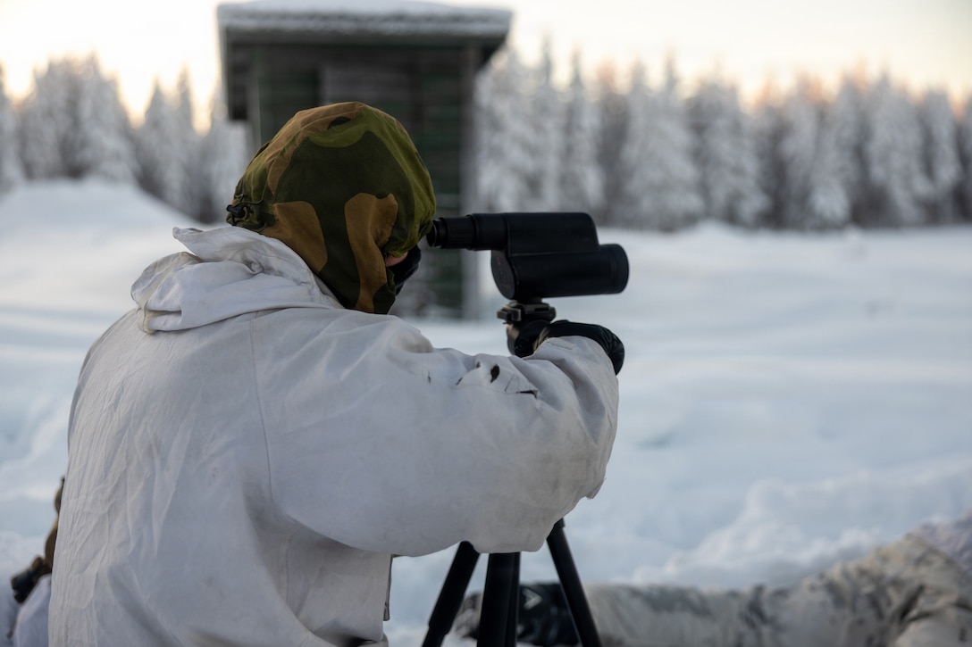 U.S. Marine Corps Staff Sgt. Barney South, a force reconnaissance Marine with 2nd Force Reconnaissance Company, 2nd Reconnaissance Battalion, 2nd Marine Division, utilizes a scout sniper observation telescope in Kalix, Sweden, Jan. 26, 2026. South used the telescope while conducting a sniper range during Advance Winter Warfare Course. The purpose of AWWC is to train ground forces in a variety of cold-weather subjects, including job specific training, snowmobiling, develop winter fighting positions, camouflage and concealment, and several other areas that are vital in order to survive and operate in a cold-weather environment. It was also conducted in preparation for exercise Cold Response 26. (U.S. Marine Corps photo by Lance Cpl. Hunter J. Kuester)