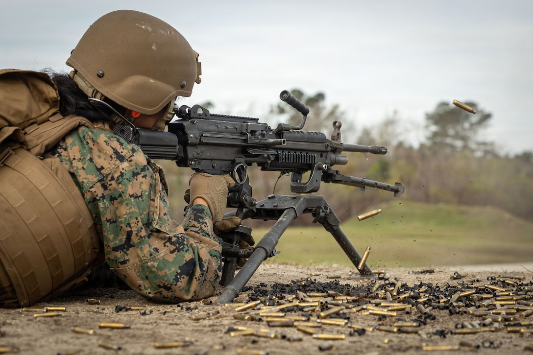 U.S. Marine Corps Lance Cpl. Brittney Camerocandela, a utilities systems technician with 2nd Maintenance Battalion, 2nd Combat Readiness Regiment, 2nd Marine Logistics Group, fires an M240B machine gun during a machine gun range at Marine Corps Base Camp Lejeune, North Carolina, March 12, 2026. The live-fire training was conducted with M240B machine guns to enhance weapons proficiency and combat readiness. Camerocandela is a native of North Carolina. (U.S. Marine Corps photo by Lance Cpl. Isabelle Veillette)