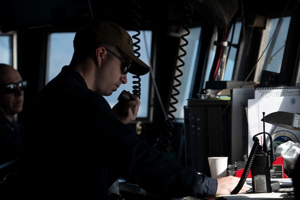 Lt. j.g. Jonah Cranford communicates over the bridge-to-bridge radio on the bridge of U.S. 7th Fleet flagship USS Blue Ridge (LCC 19) as the ship prepares to enter port in Manila, Philippines, March 16, 2026.