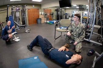 *Training* Hospitalman Joshua Shackleford, kneeling, reviews his training scenario with Justin Oakley, left, a Firefighter Emergency Medical Technician, during the testing portion of an Emergency Medical Technician-Basic course hosted by the MCAS Cherry Point Fire and Emergency Services Department on March 11, 2026.  Shackleford and other Sailors assigned to Navy Medicine Readiness and Training Command Cherry Point participated in the training to enhance their skills and knowledge in providing emergency medical care in various scenarios.