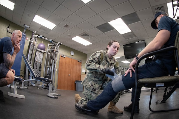 *Training* Hospitalman Johanna Myers, center, applies a pressure dressing to a simulated victim experiencing severe bleeding as Justin Oakley, a Firefighter Emergency Medical Technician, evaluates her performance during the testing portion of an Emergency Medical Technician-Basic course hosted by the MCAS Cherry Point Fire and Emergency Services Department on March 11, 2026.  Myers and other Sailors assigned to Navy Medicine Readiness and Training Command Cherry Point participated in the training to enhance their skills and knowledge in providing emergency medical care in various scenarios.