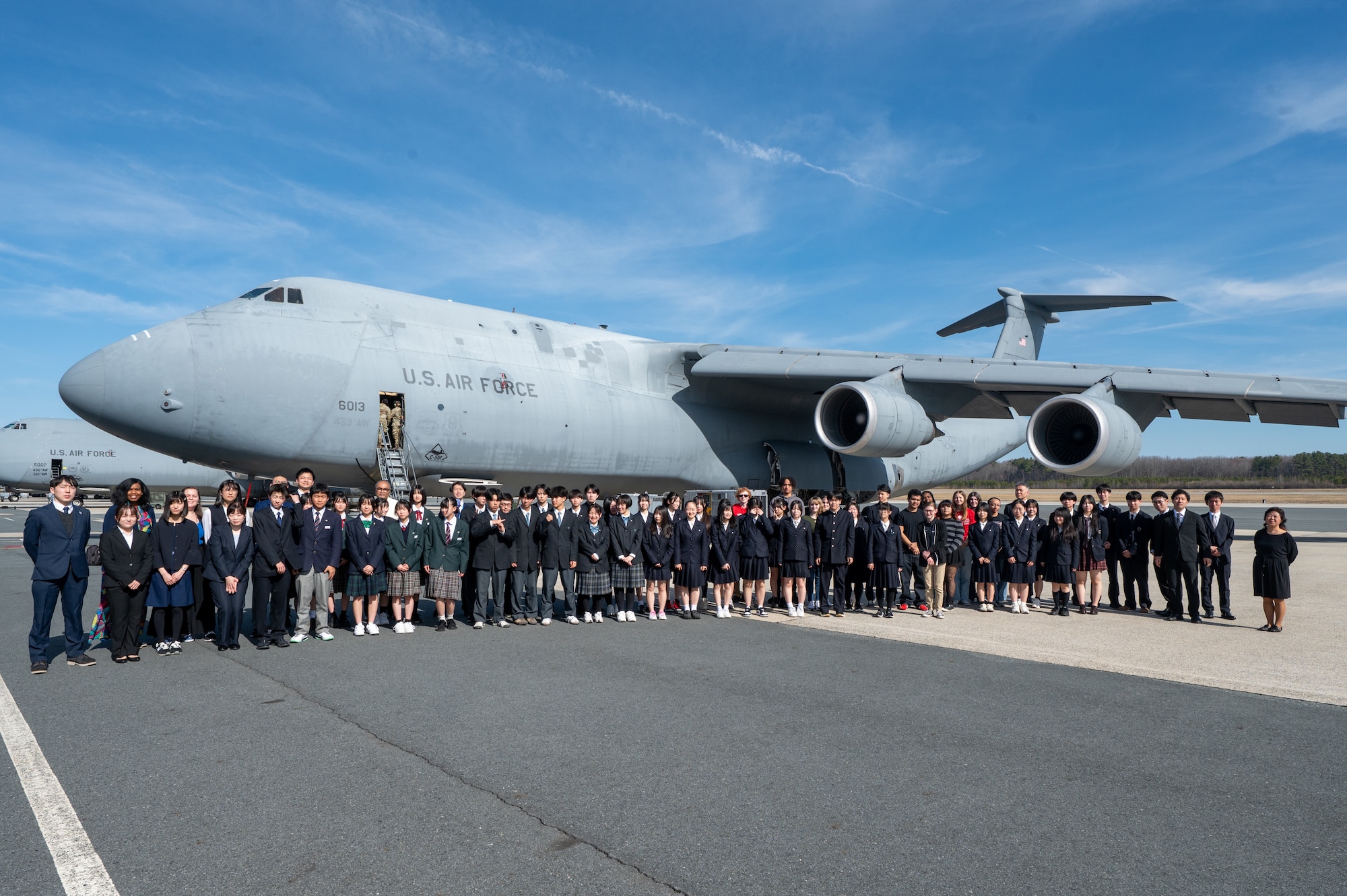 Students and teachers from Miyagi, Japan pose in front of a C-5M Super Galaxy at Dover Air Force Base, Delaware, March 10, 2026. Delaware and Miyagi are sister states that foster business, education and cultural exchanges through annual visits. (U.S. Air Force photo by Mauricio Campino)