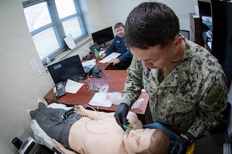 *Training* Hospitalman Logan Wiley, right, inserts a nasopharyngeal airway into a simulated patient experiencing respiratory distress as Lt. Eric Slaughter, an Emergency Medical Technician, evaluates his performance during the testing portion of an Emergency Medical Technician-Basic course hosted by the MCAS Cherry Point Fire and Emergency Services Department on March 11, 2026.  Wiley and other Sailors assigned to Navy Medicine Readiness and Training Command Cherry Point participated in the training to enhance their skills and knowledge in providing emergency medical care in various scenarios.