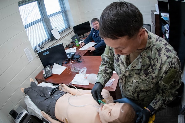 *Training* Hospitalman Logan Wiley, right, inserts a nasopharyngeal airway into a simulated patient experiencing respiratory distress as Lt. Eric Slaughter, an Emergency Medical Technician, evaluates his performance during the testing portion of an Emergency Medical Technician-Basic course hosted by the MCAS Cherry Point Fire and Emergency Services Department on March 11, 2026.  Wiley and other Sailors assigned to Navy Medicine Readiness and Training Command Cherry Point participated in the training to enhance their skills and knowledge in providing emergency medical care in various scenarios.