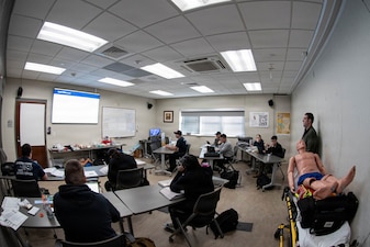 Daniel Whitehead, right, assistant fire chief of operations of Cherry Point FEMS and an Emergency Medical Technician, instructs Navy Corpsmen how to identify and respond to a patient experiencing heart failure during an Emergency Medical Technician-Basic course conducted aboard Marine Corps Air Station Cherry Point on March 5, 2026.  The Corpsmen, who are assigned to Navy Medicine Readiness and Training Command Cherry Point, participated in the training to enhance their skills and knowledge in providing emergency medical care in various scenarios.
