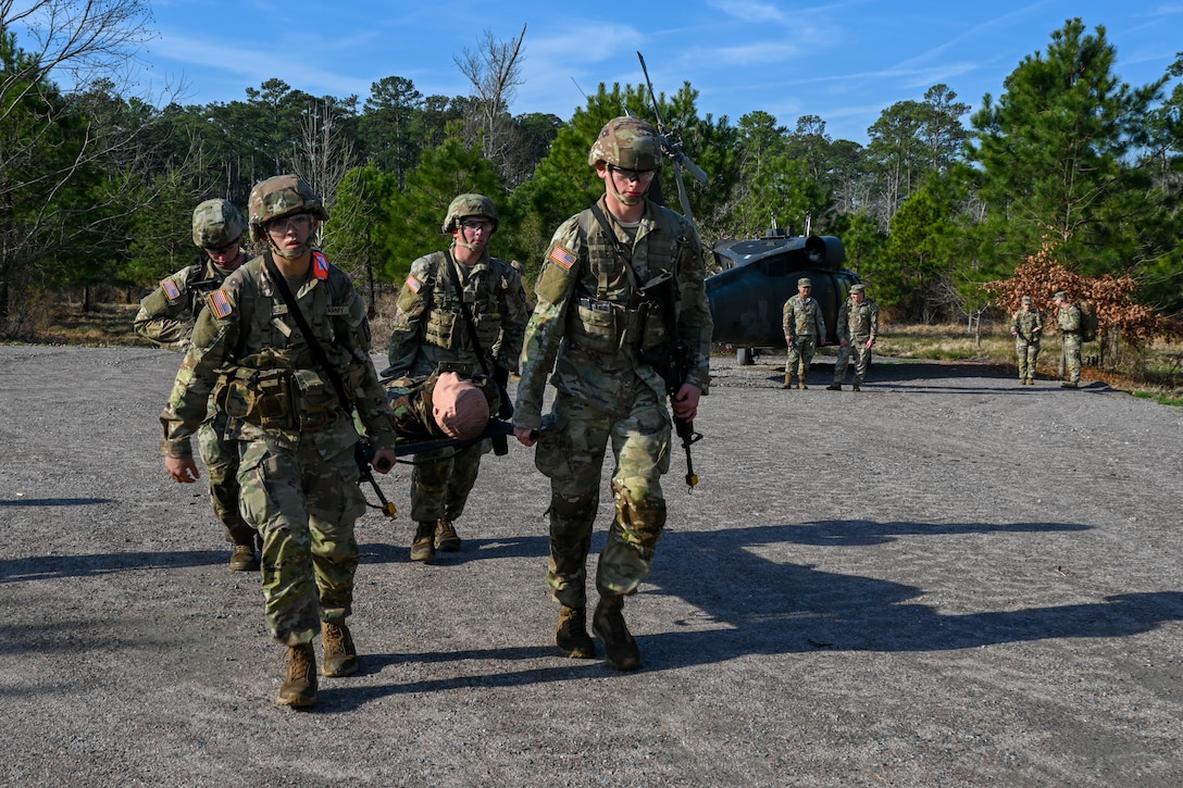 Soldiers carry a training dummy in a stretcher. (U.S. Air Force photo by Airman 1st Class Donnell Ramsey)