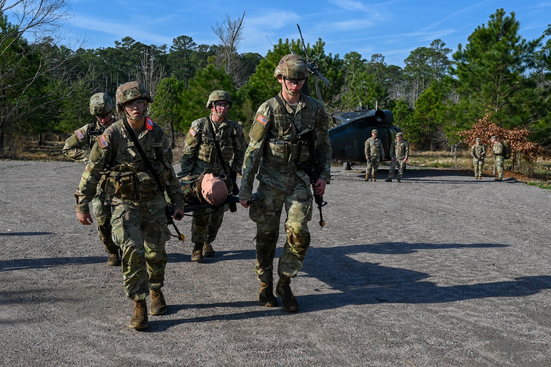 Soldiers carry a training dummy in a stretcher. (U.S. Air Force photo by Airman 1st Class Donnell Ramsey)